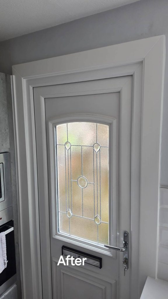 After: closer view of the new white back door and its decorative glass panel