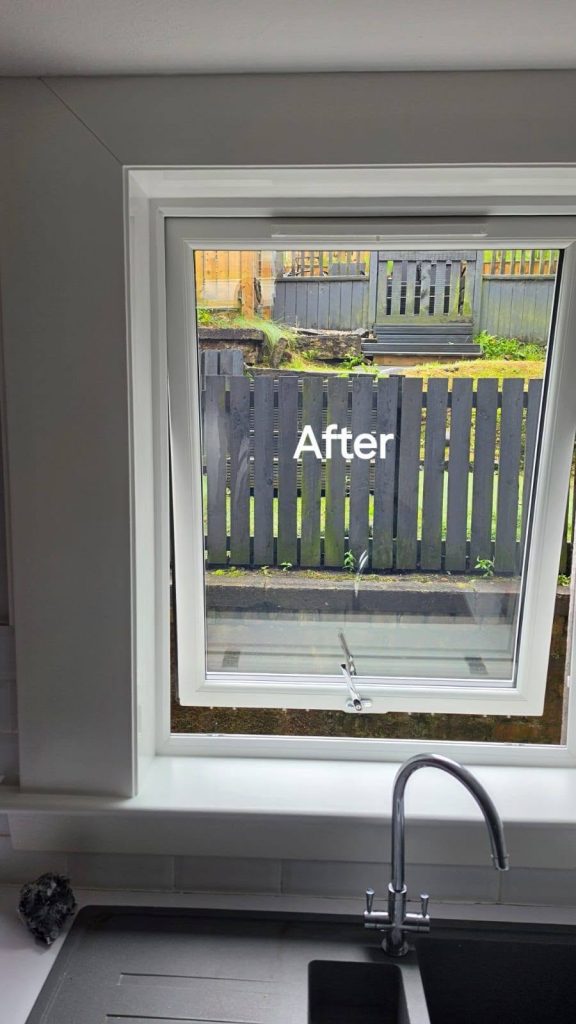 After: new white uPVC kitchen window above the sink, looking out to the garden fence