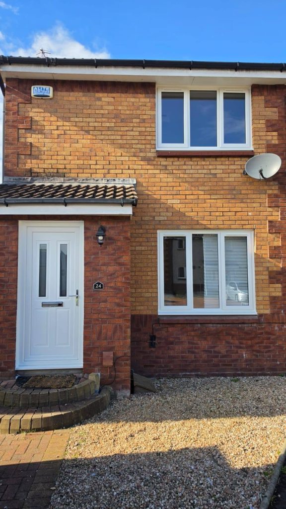 Outside of a Yoker house with a new white front door and white uPVC windows