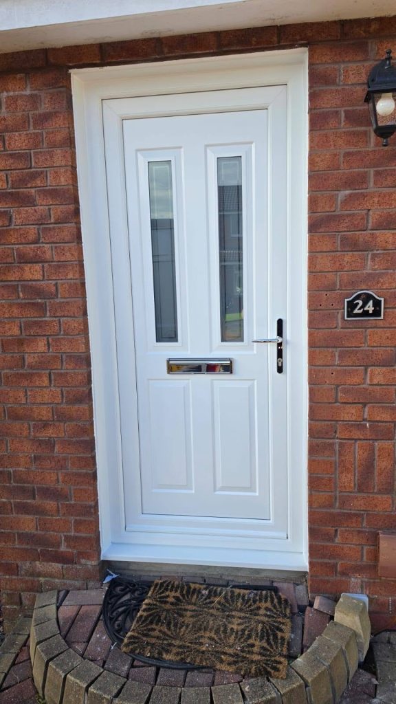 New white front door with two tall glazed panels on a red-brick house in Yoker