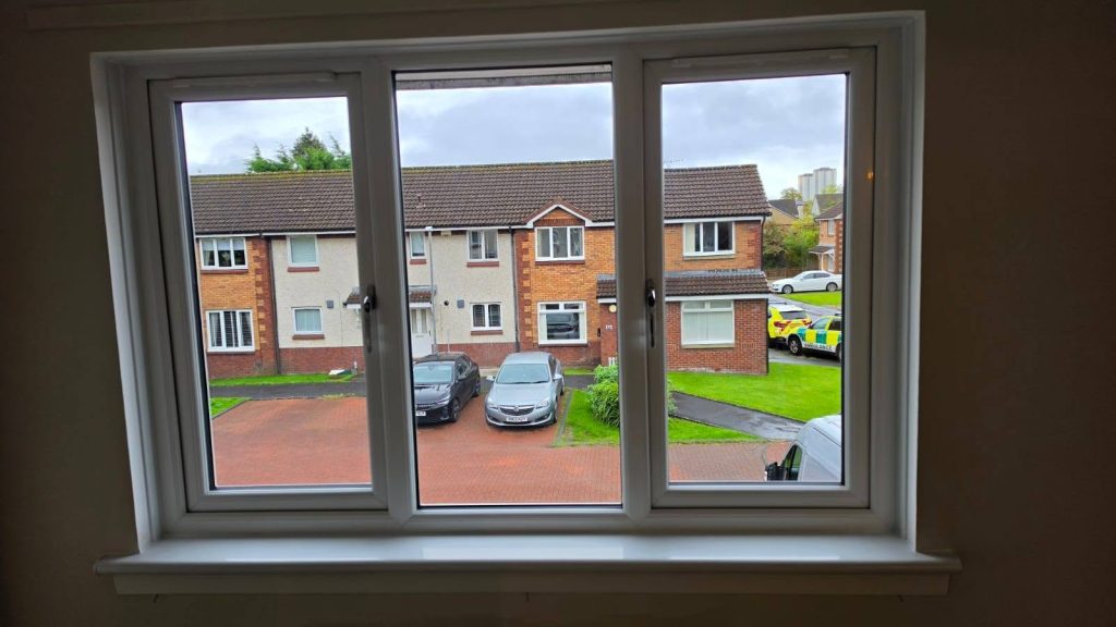 Wider view of a new white three-pane Rehau uPVC window fitted in a Yoker home