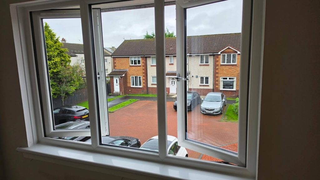 New white Rehau uPVC window in a Yoker home, seen from inside with one sash open